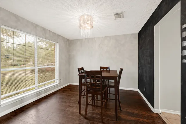 a view of a dining room with furniture and wooden floor