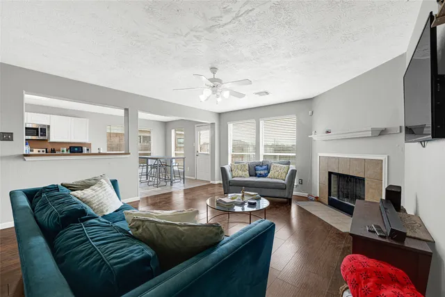 a living room with furniture fireplace and flat screen tv