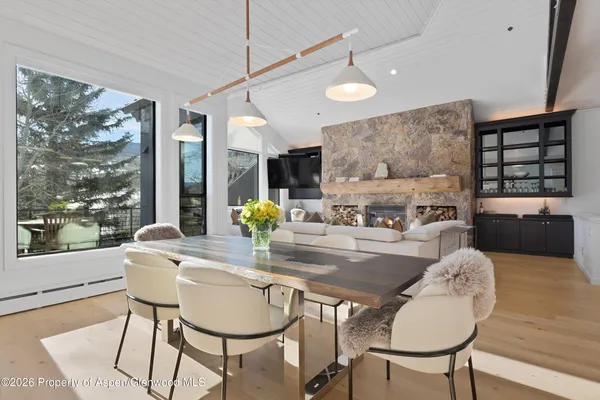 a dining room with furniture and wooden floor