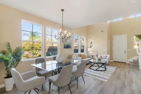 a kitchen with stainless steel appliances kitchen island granite countertop a refrigerator and a sink