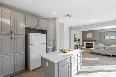 a view of an empty room with wooden floor and windows