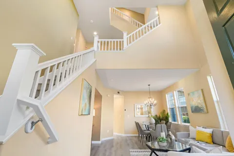 a bedroom with a bed a mirror and a window