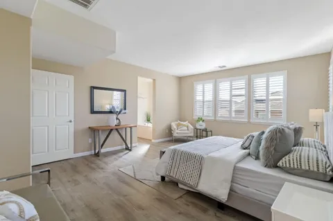 a bedroom with bed and a window