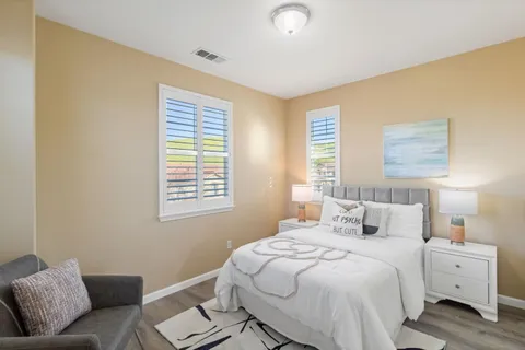 a view of a room with a window and a chair