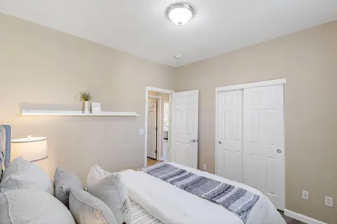 a en suite bathroom with a granite countertop tub sink and mirror