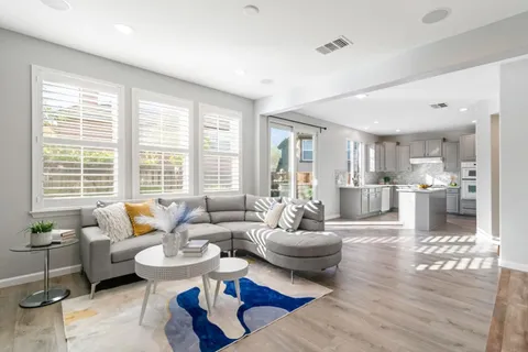 a kitchen with stainless steel appliances granite countertop a stove a sink and a white cabinets