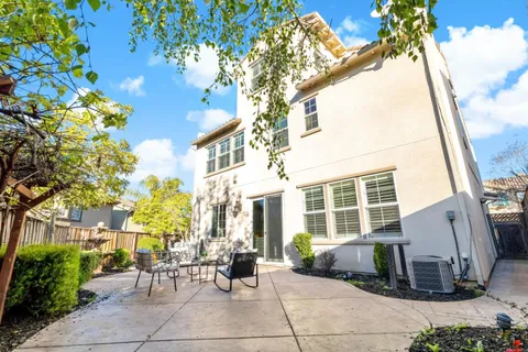 an aerial view of ocean and residential houses with outdoor space