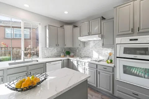 a bedroom with a bed a table and chair