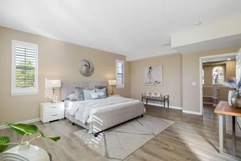 a front view of a house with a garden and plants