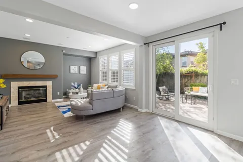 a view of a dining room with furniture a chandelier and wooden floor