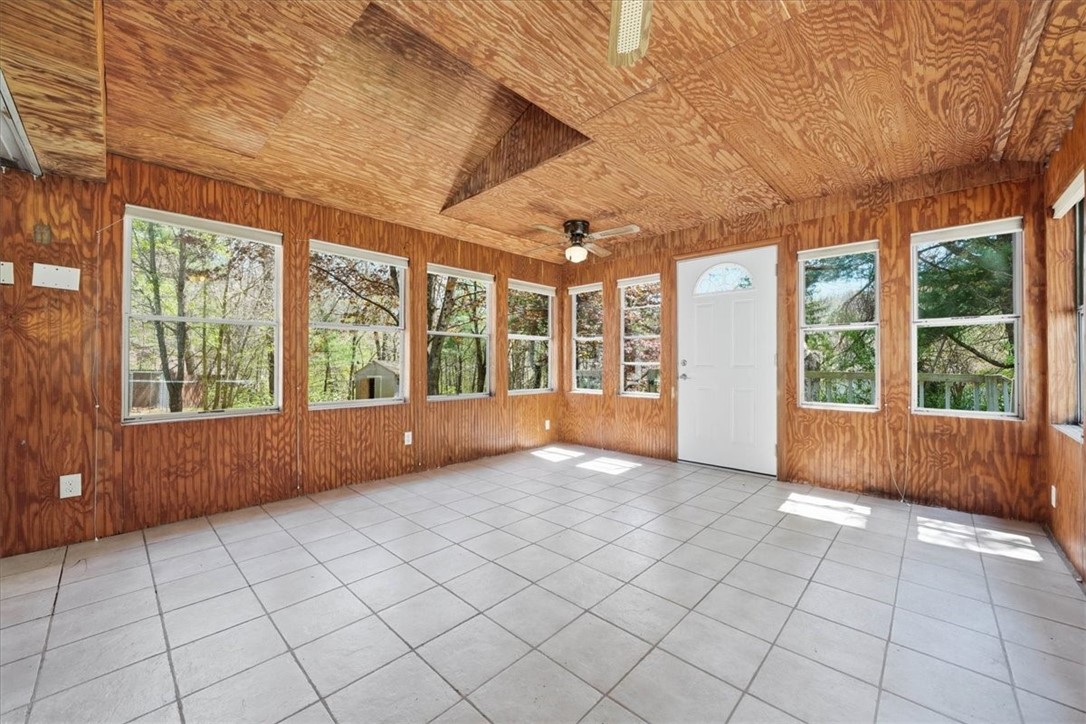 322 Rocky Hill Road Scituate, RI 02857 - Photo 30 of 50 Featuring vaulted wood ceilings, tile flooring, and multiple ceiling fans, this space is perfect for relaxing, entertaining, or enjoying morning coffee while overlooking the private backyard.