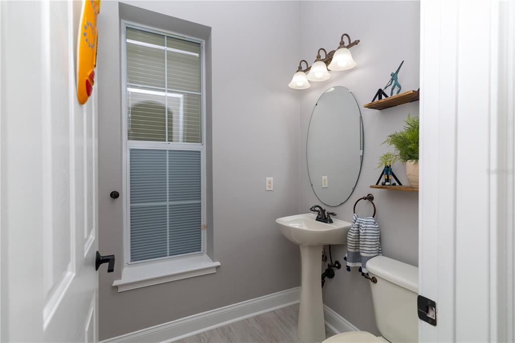 3305 Schoolhouse Road St. Cloud, FL 34773 - Photo 37 of 83 a bathroom with a sink a mirror and a window