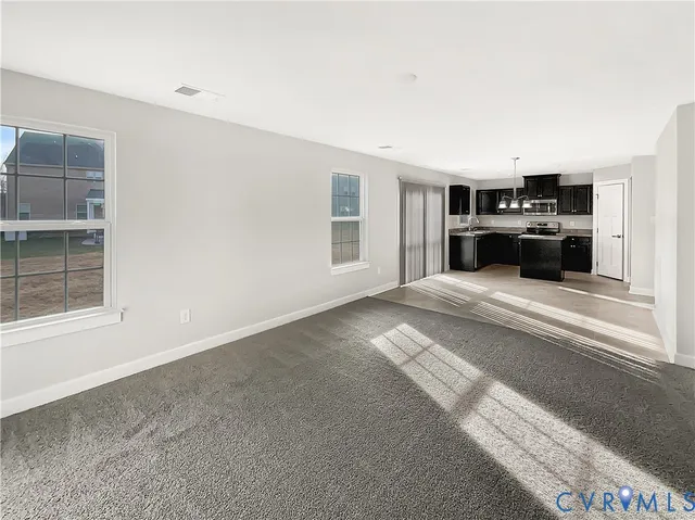 a view of a kitchen with a sink dishwasher and a fireplace
