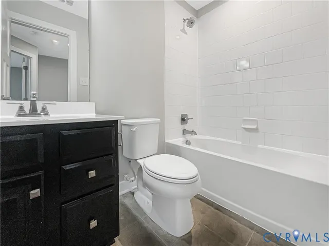 a bathroom with a sink toilet vanity and shower