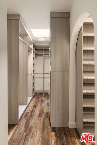 a bathroom with a granite countertop shower a sink and a mirror