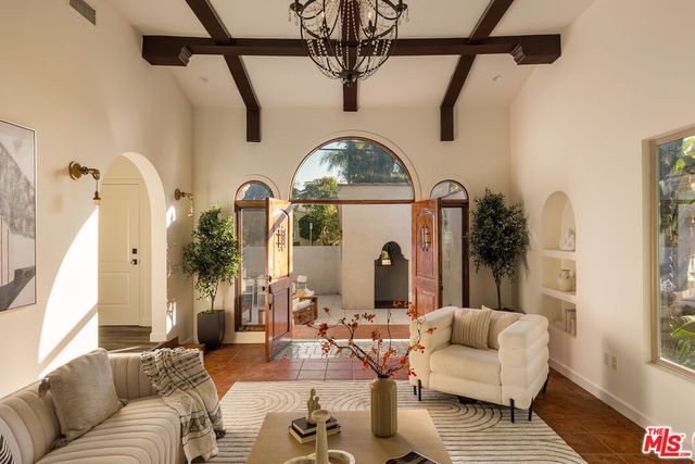 a living room with furniture and a potted plant