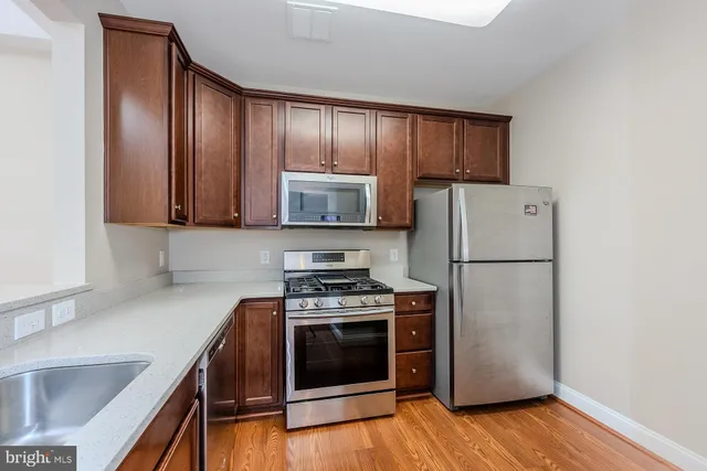 a bathroom with a double vanity sink a mirror and a bathtub