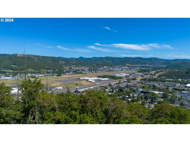 a open area with mountains in the background