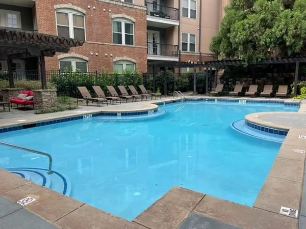 a view of a house with pool and sitting area