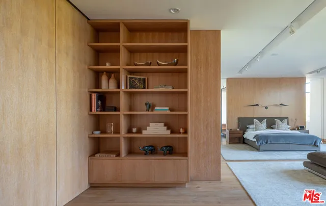 a living room with furniture and a book shelf