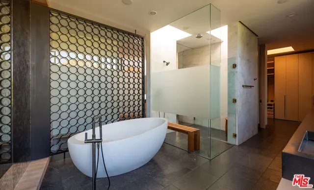 a bathroom with a bathtub and shower