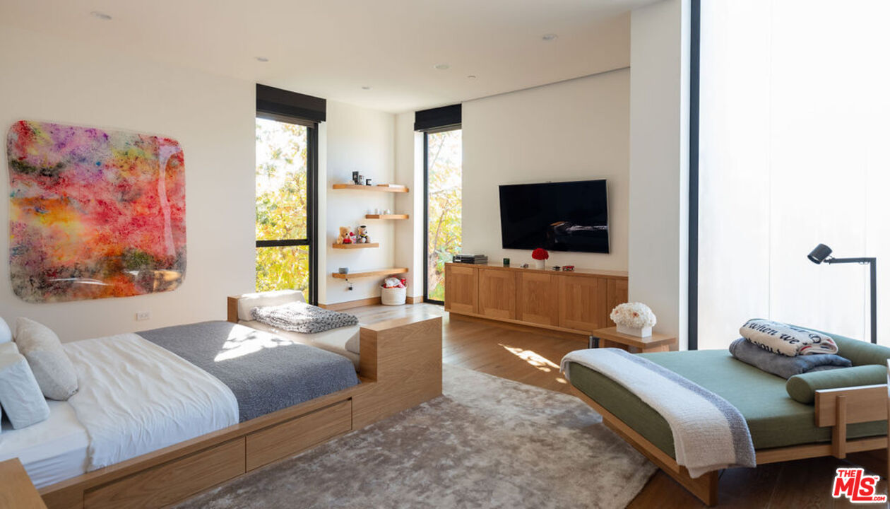 3350 Stoneridge Lane Los Angeles, CA 90077 - Photo 23 of 42 a bedroom with a bed and a flat screen tv