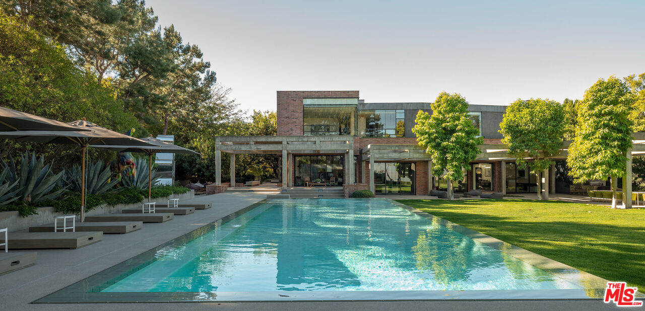 3350 Stoneridge Lane Los Angeles, CA 90077 - Photo 3 of 42 a view of a swimming pool with a patio