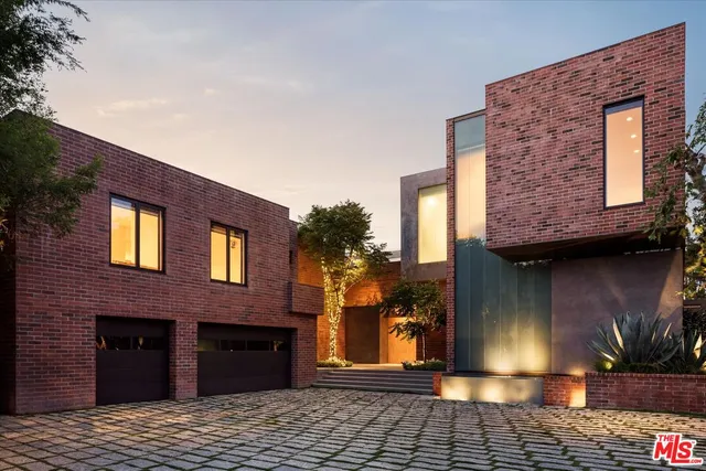 a view of a brick house with a door and a table