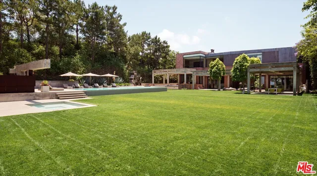 a view of house with outdoor space and swimming pool