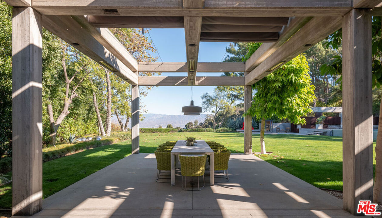 3350 Stoneridge Lane Los Angeles, CA 90077 - Photo 38 of 42 a view of a patio with a table chairs and a garden