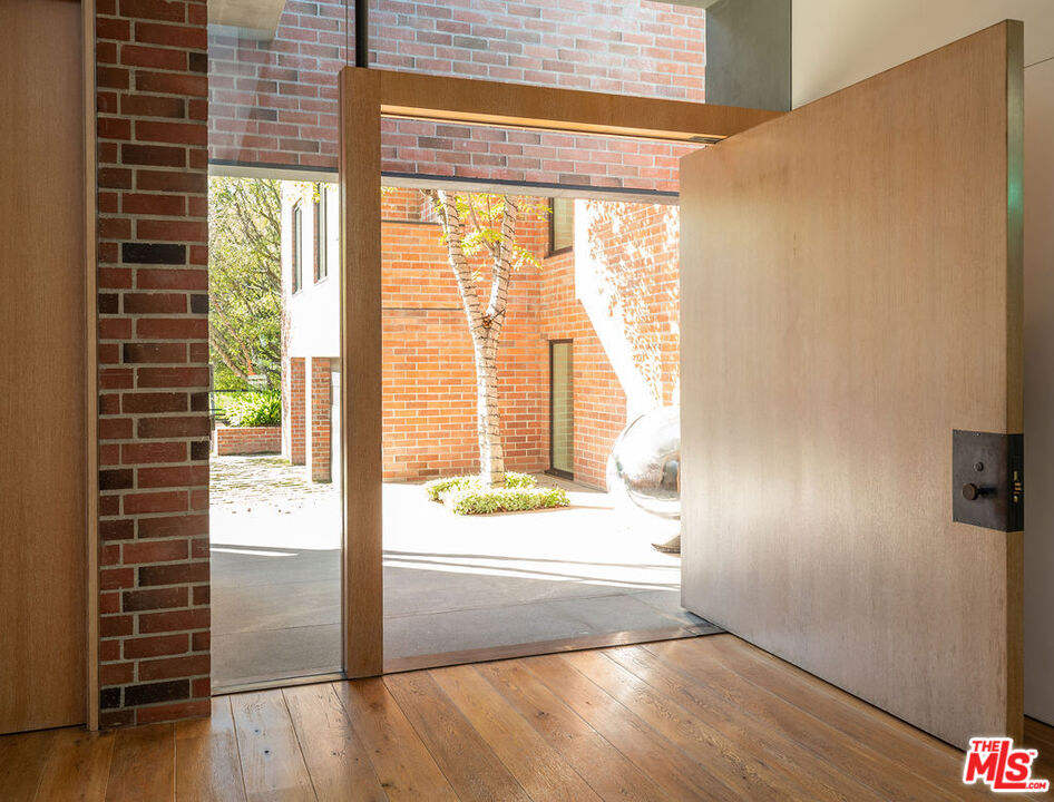 3350 Stoneridge Lane Los Angeles, CA 90077 - Photo 5 of 42 a view of an empty room with wooden floor and windows