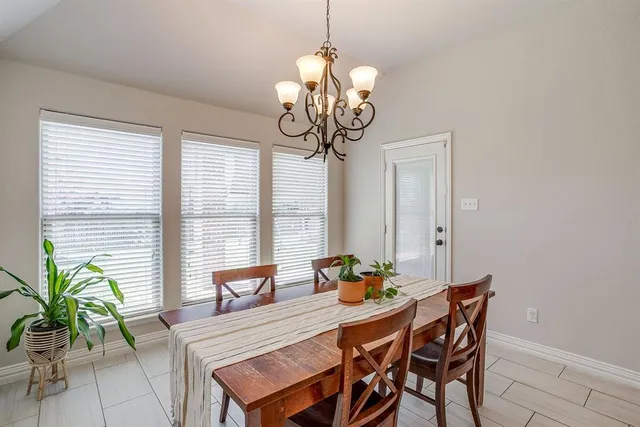 a kitchen with a dining table and chairs