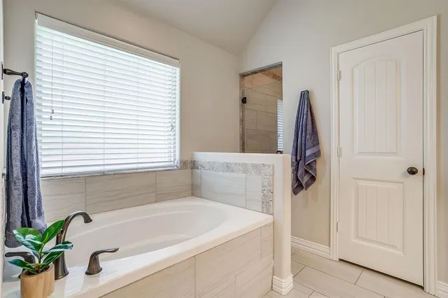 a bathroom with double vanity sink and a mirror