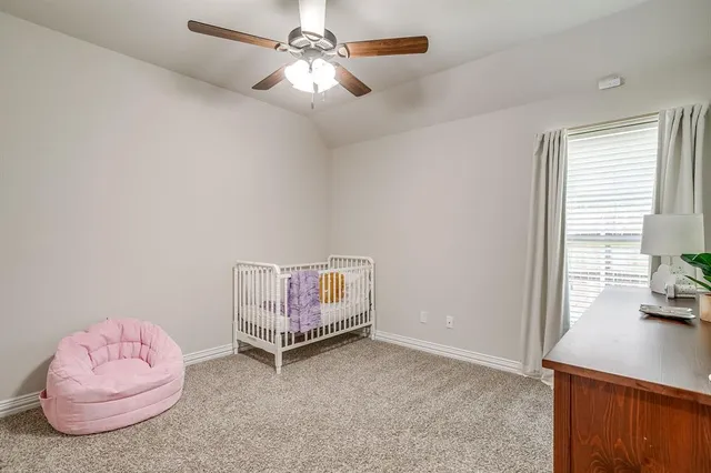 a bathroom with a granite countertop sink a toilet a mirror and shower