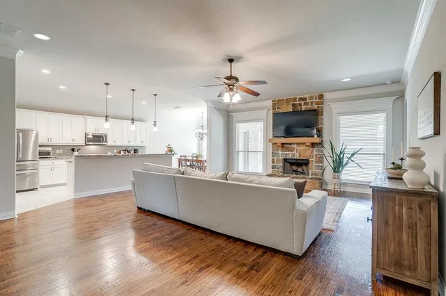 a living room with kitchen island furniture and a chandelier