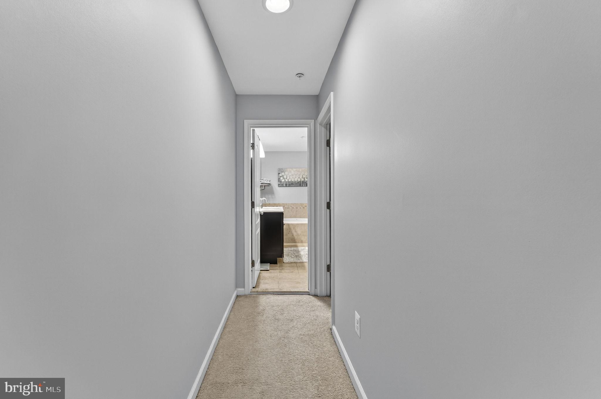 42558 Sunset Ridge Square Ashburn, VA 20148 - Photo 36 of 51 a view of a hallway with wooden floor