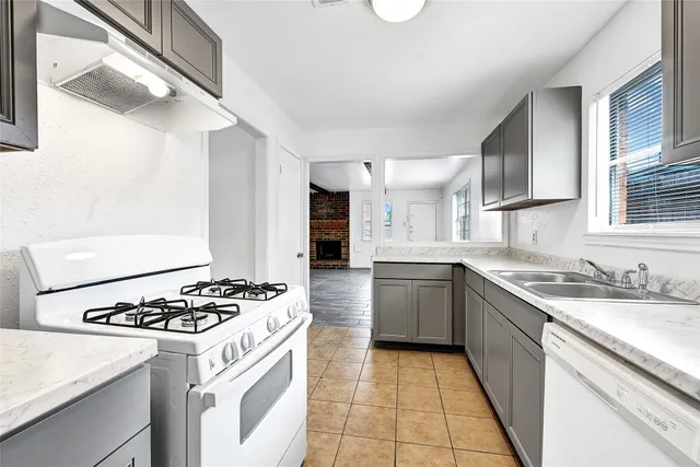 a kitchen with a stove a sink and a refrigerator