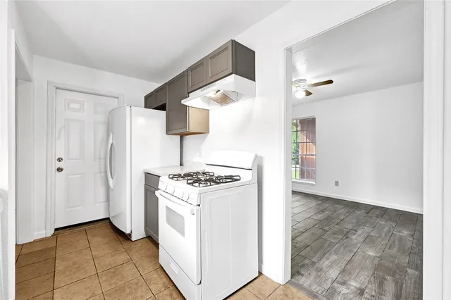 a kitchen with a stove and a refrigerator