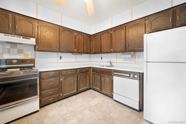 a kitchen with a sink a stove and cabinets