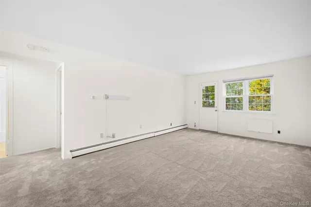 an empty room with a empty space and window