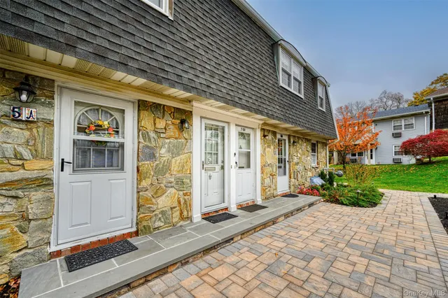 a view of a brick house with many windows