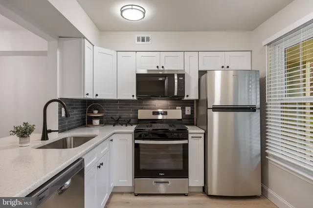 a kitchen with stainless steel appliances a refrigerator stove and sink