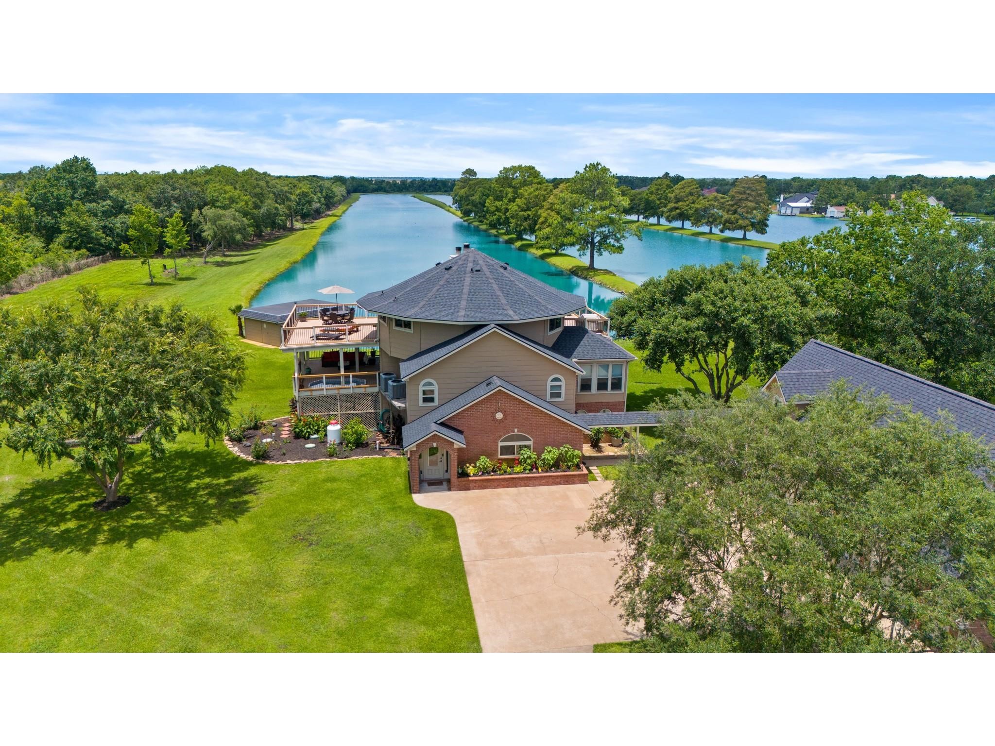 6714 Spray Lane, Unit C699A Rosharon, TX 77583 - Photo 2 of 48 Welcome Home to 6714 Spray Lane. Stop Scrolling! THis home has SO MANY FEATURES! Private LAKEFRONT .76 acre lot, 3700+ sq ft Main Home, 4 Car Garage with 2 Upstairs Garage Apartments