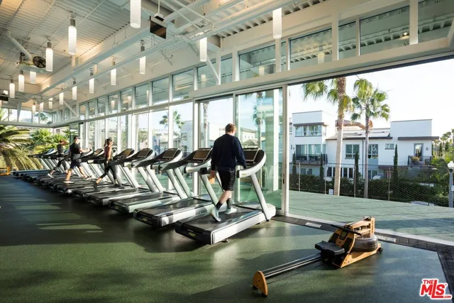 a view of a swimming pool with a patio and lake view