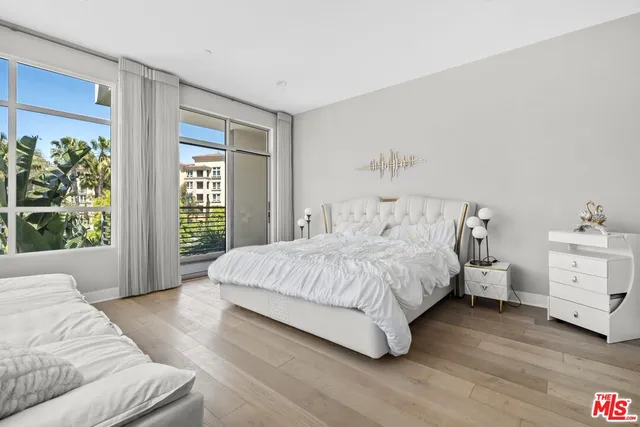 a spacious bedroom with a bed and a couch