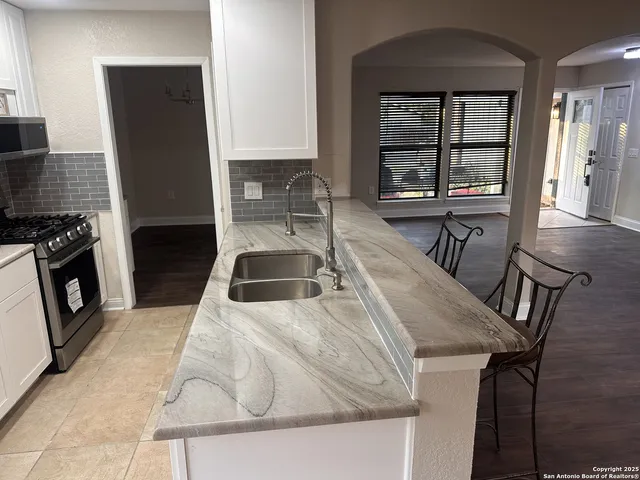 a kitchen with a table chairs and a stove