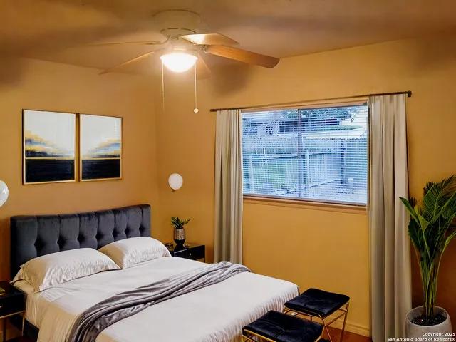 a bedroom with a bed and a potted plant