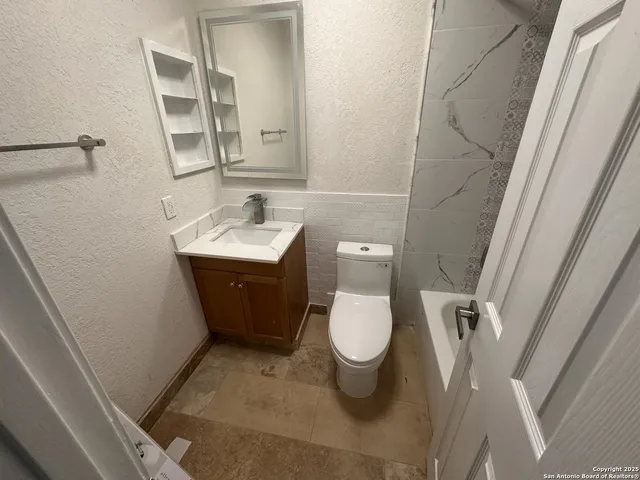 a bathroom with a sink toilet and mirror