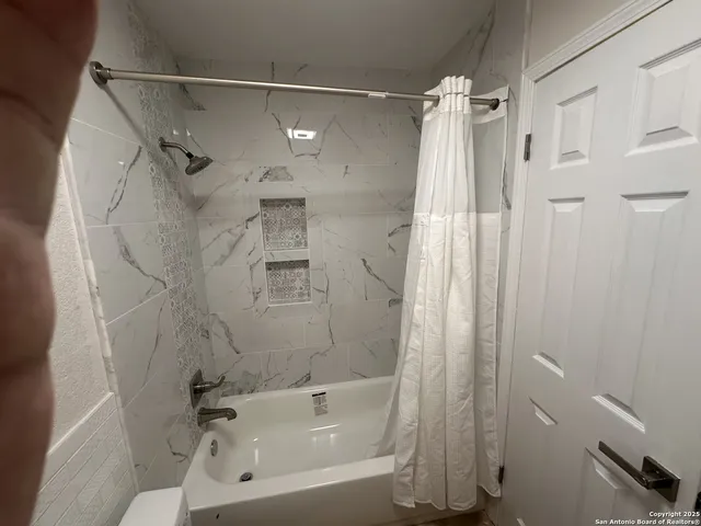 a bathroom with a shower and a tub