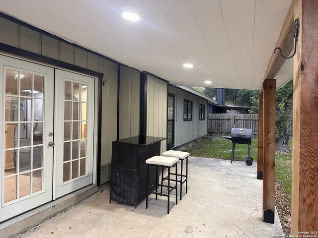 a view of a porch with furniture and next to a yard